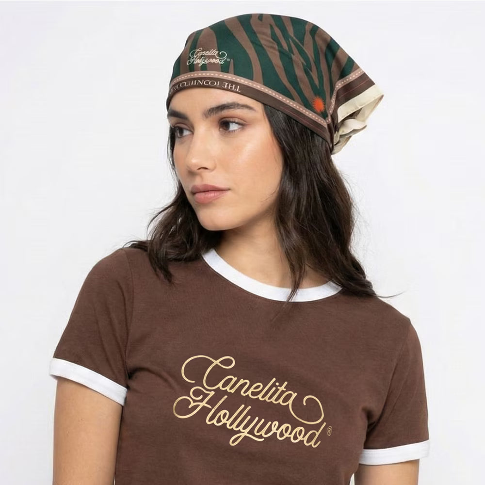 Mujer con la pañoleta en la cabeza y camiseta de la marca – Pañoleta Iconic de Canelita Hollywood | Nova Oficial
